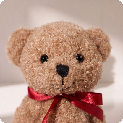 Teddy bear marrón con lazo rojo
