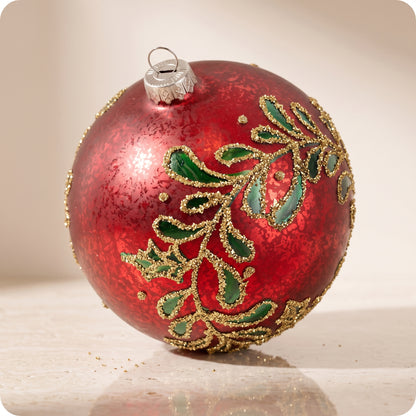 Esfera de cristal rojo con hojas verdes y brillos dorados 12 cm