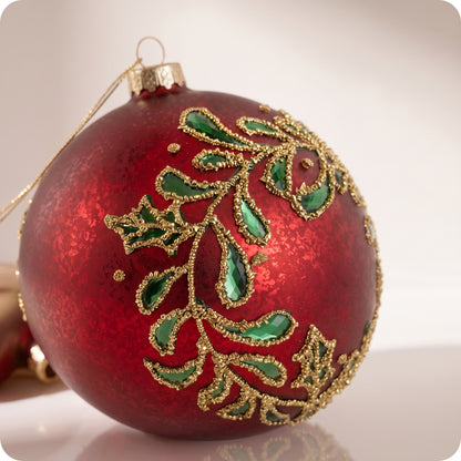 Esfera de cristal rojo con hojas verdes y brillos dorados 12 cm
