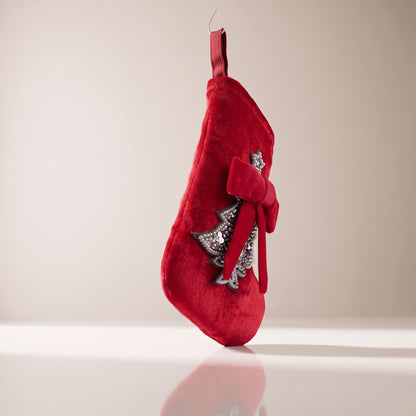 Bota de terciopelo con árbol y lazo rojo