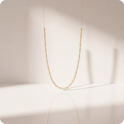 Guirnalda de pearl string doradas